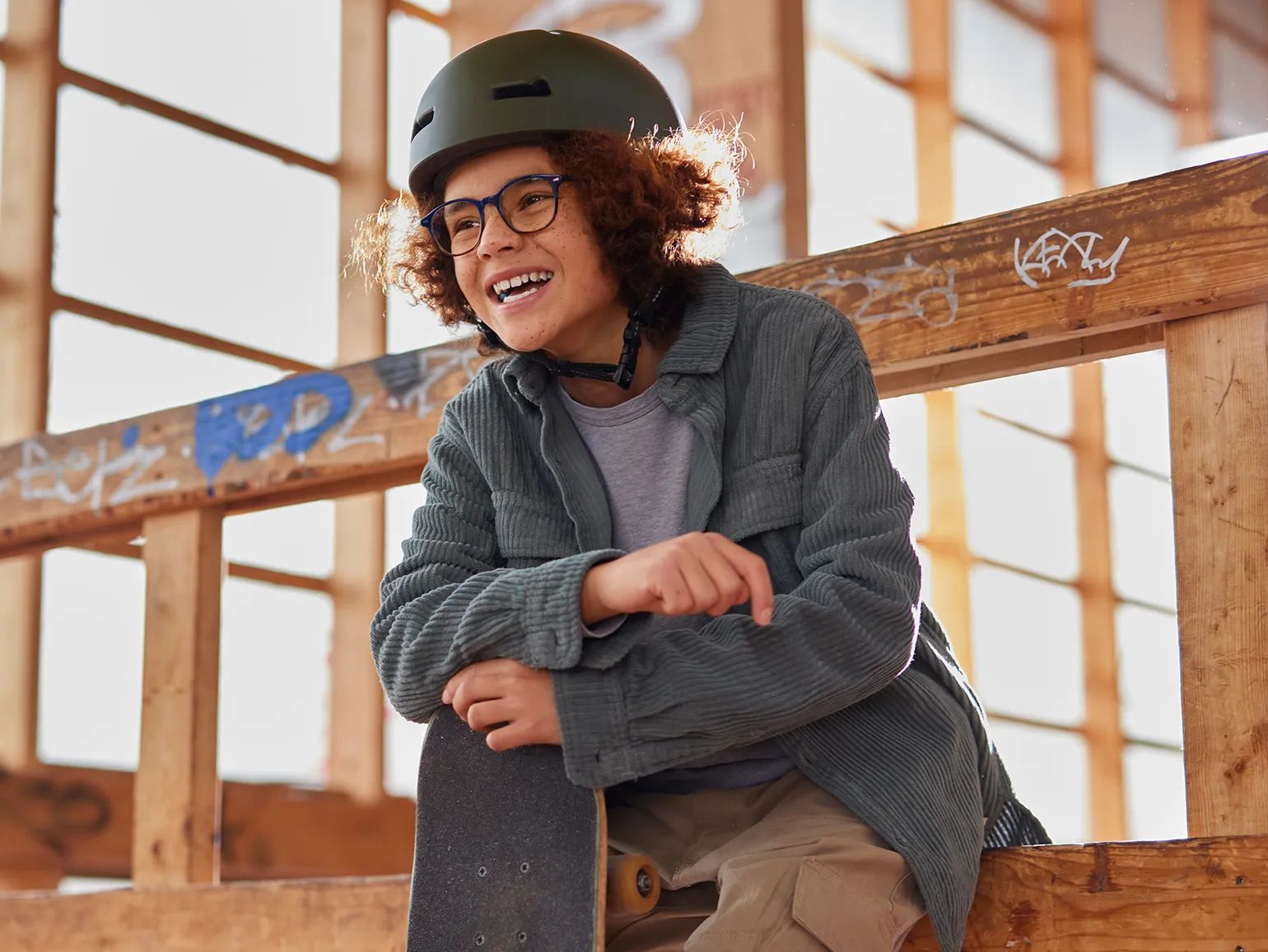 Child on a skate ramp wearing a pair of round glasses